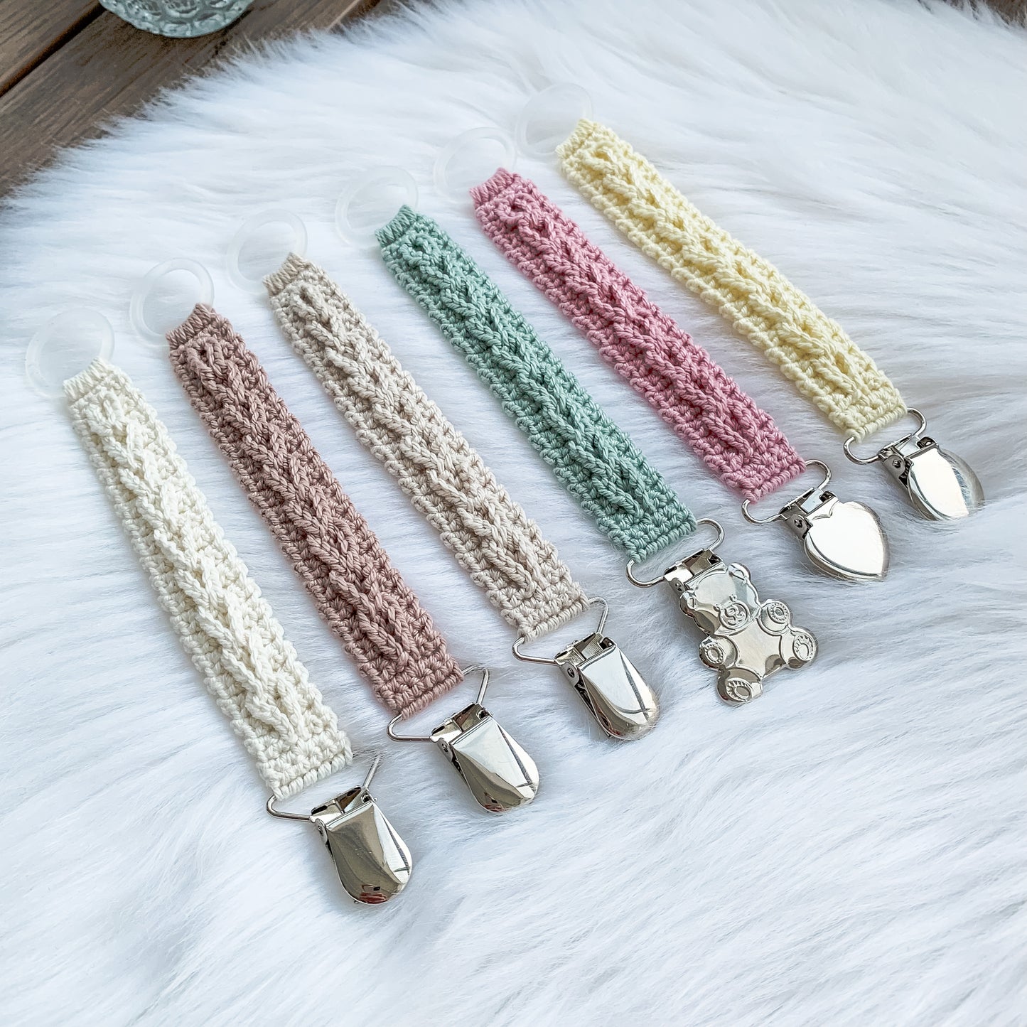 Easy crochet pacifier holder pattern for handmade baby gifts and Scandinavian nursery styling.