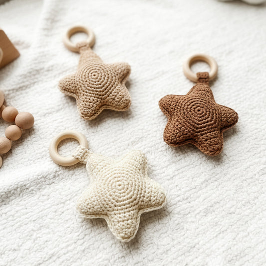 Crochet baby star rattle pattern with soft plush yarn and Scandinavian-inspired nursery styling.