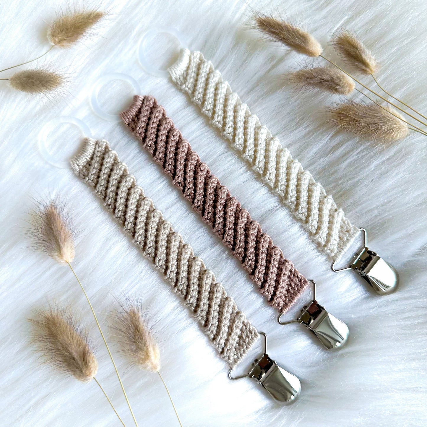 Crochet pacifier clip pattern Frej with Scandinavian-inspired handmade baby styling and soft neutral textures.