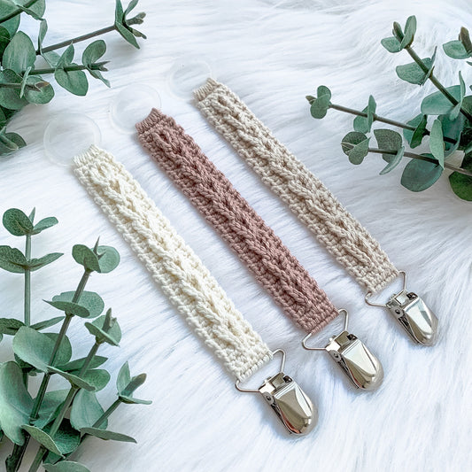 Crochet pacifier clip pattern Sigrid with Scandinavian-inspired handmade baby styling and soft neutral colors.