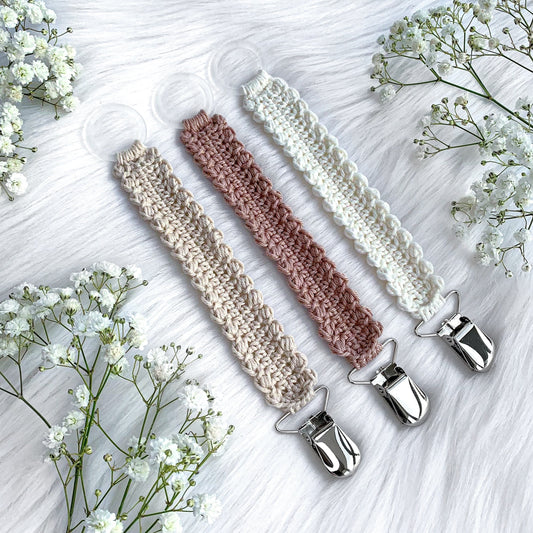 Crochet pacifier clip pattern Vera with soft Scandinavian-inspired baby styling and handmade details.