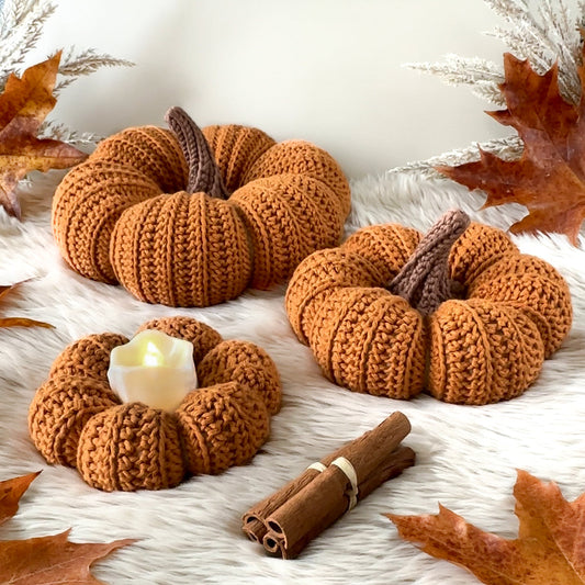 Crochet pumpkin pattern with textured Scandinavian-inspired autumn decor in neutral tones.