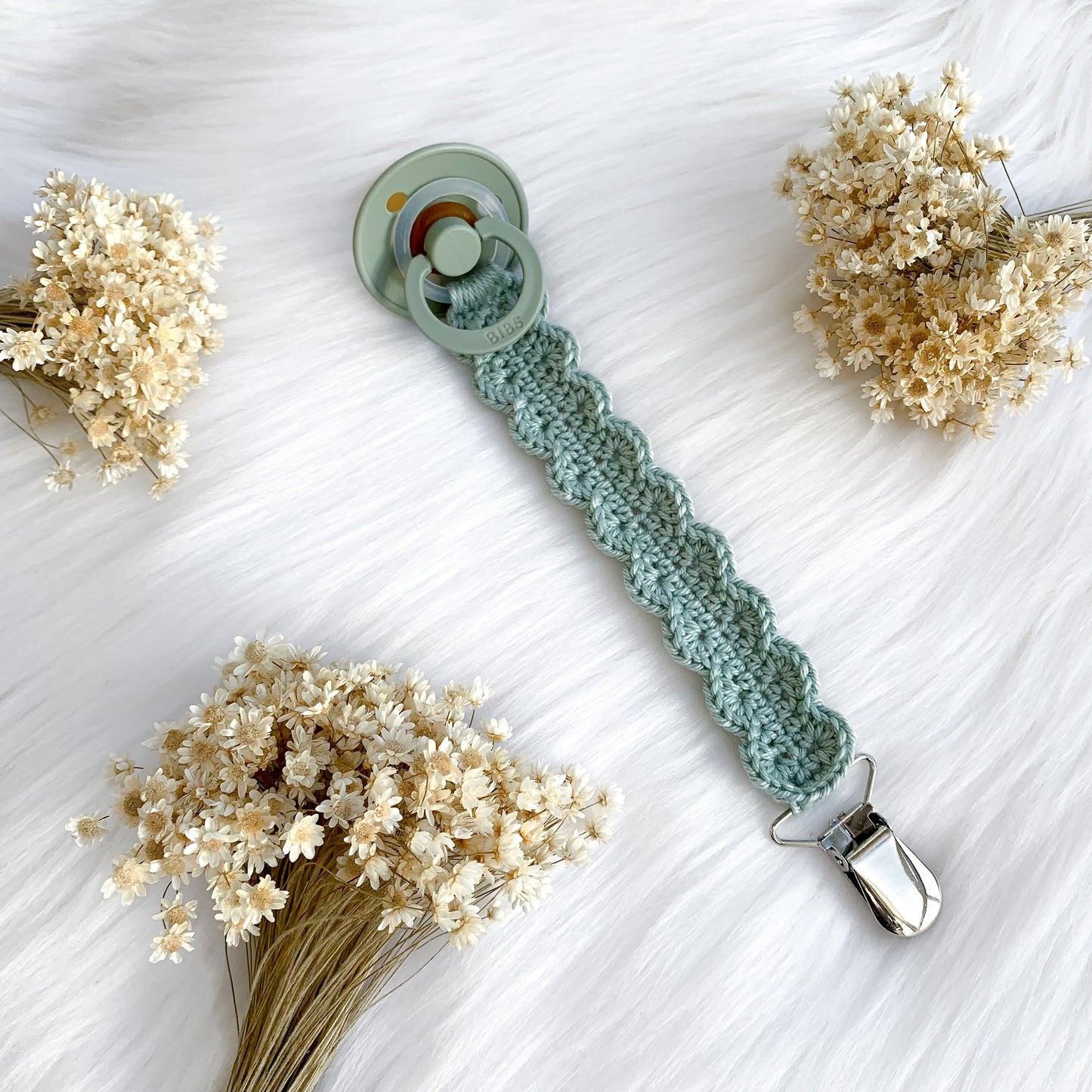 Easy crochet pacifier clip pattern for handmade baby gifts and minimalist nursery styling.