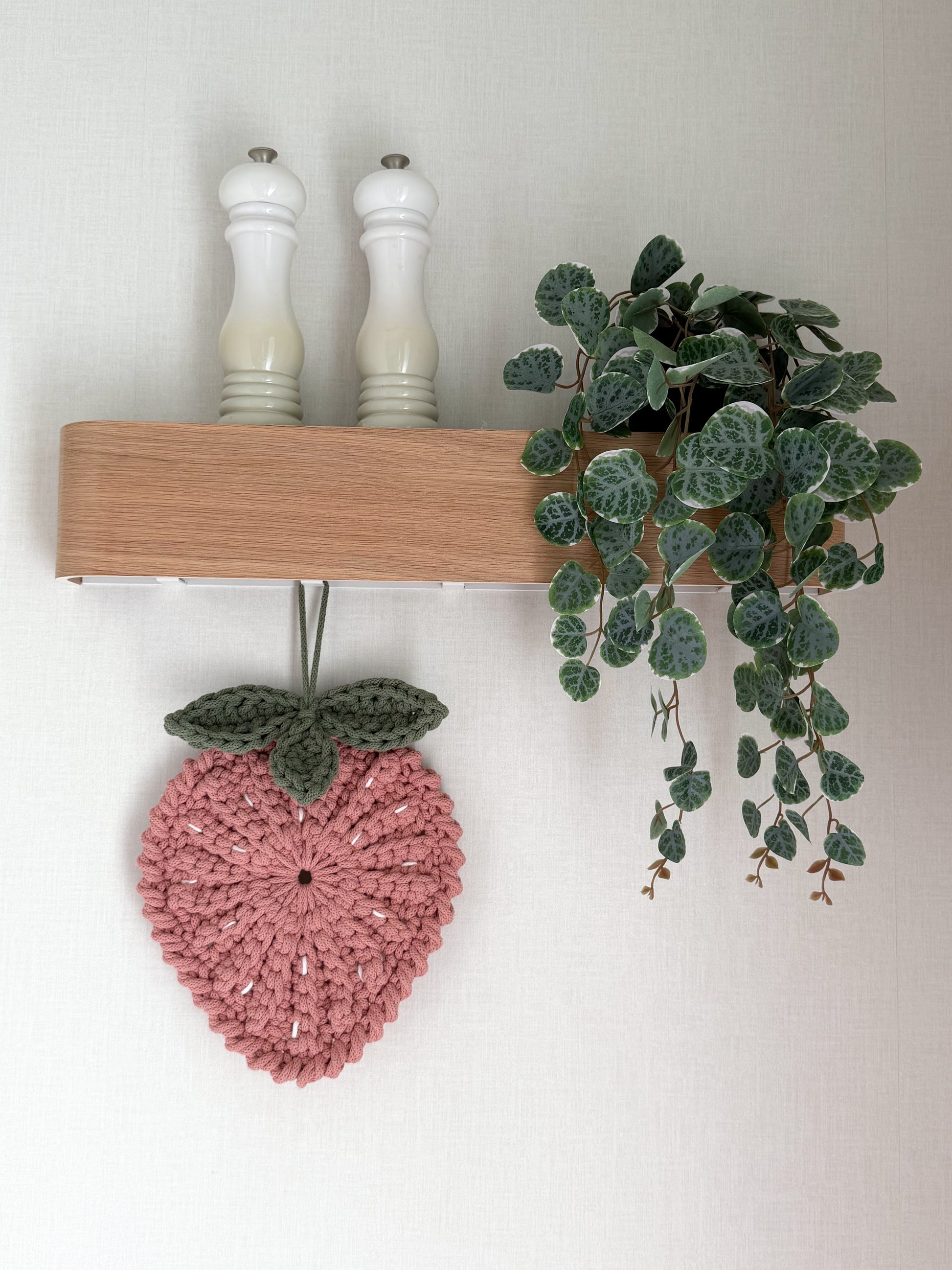 Pink crochet strawberry trivet for kitchen decoration