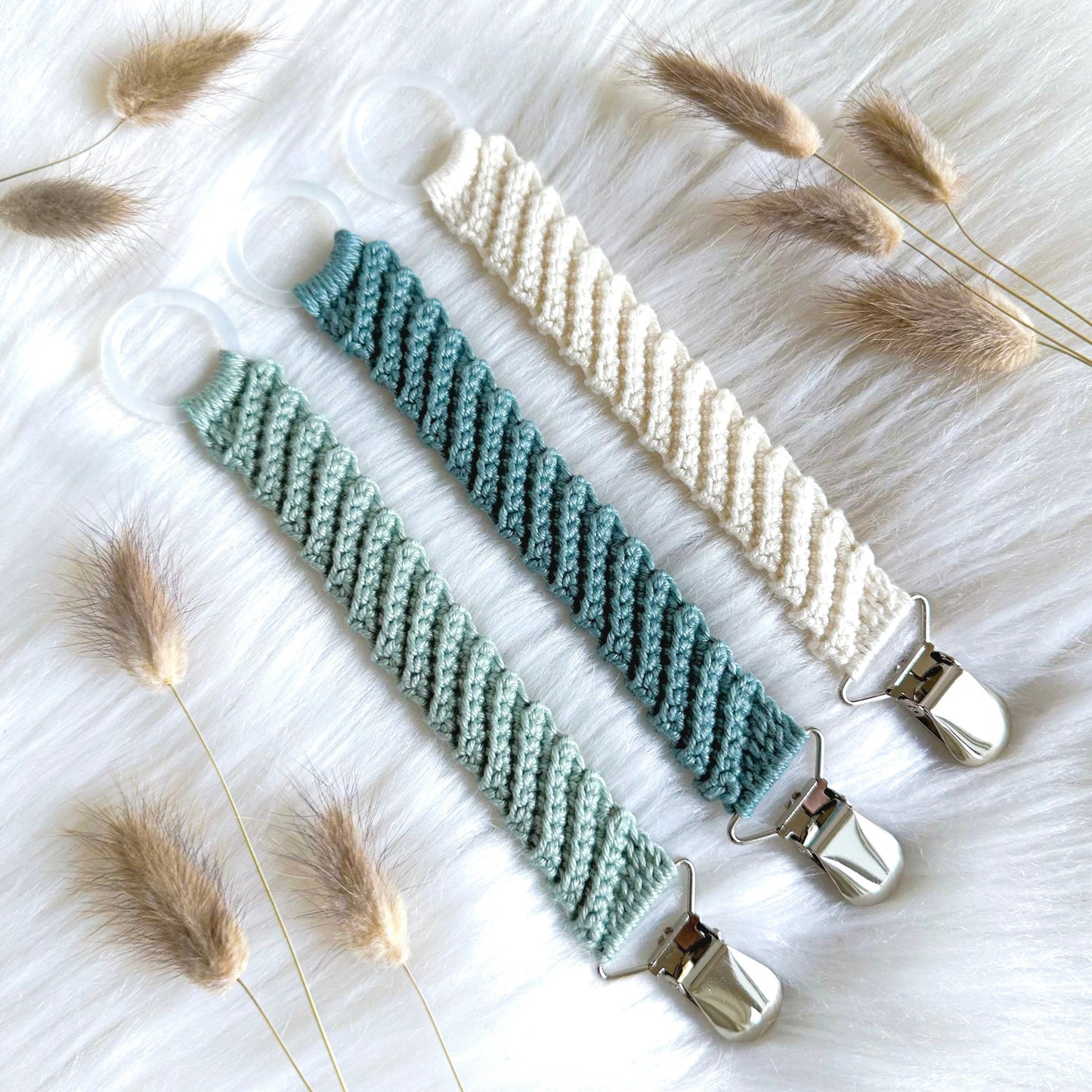 Handmade crochet baby pacifier holder pattern designed for modern nursery decor and baby gifts.