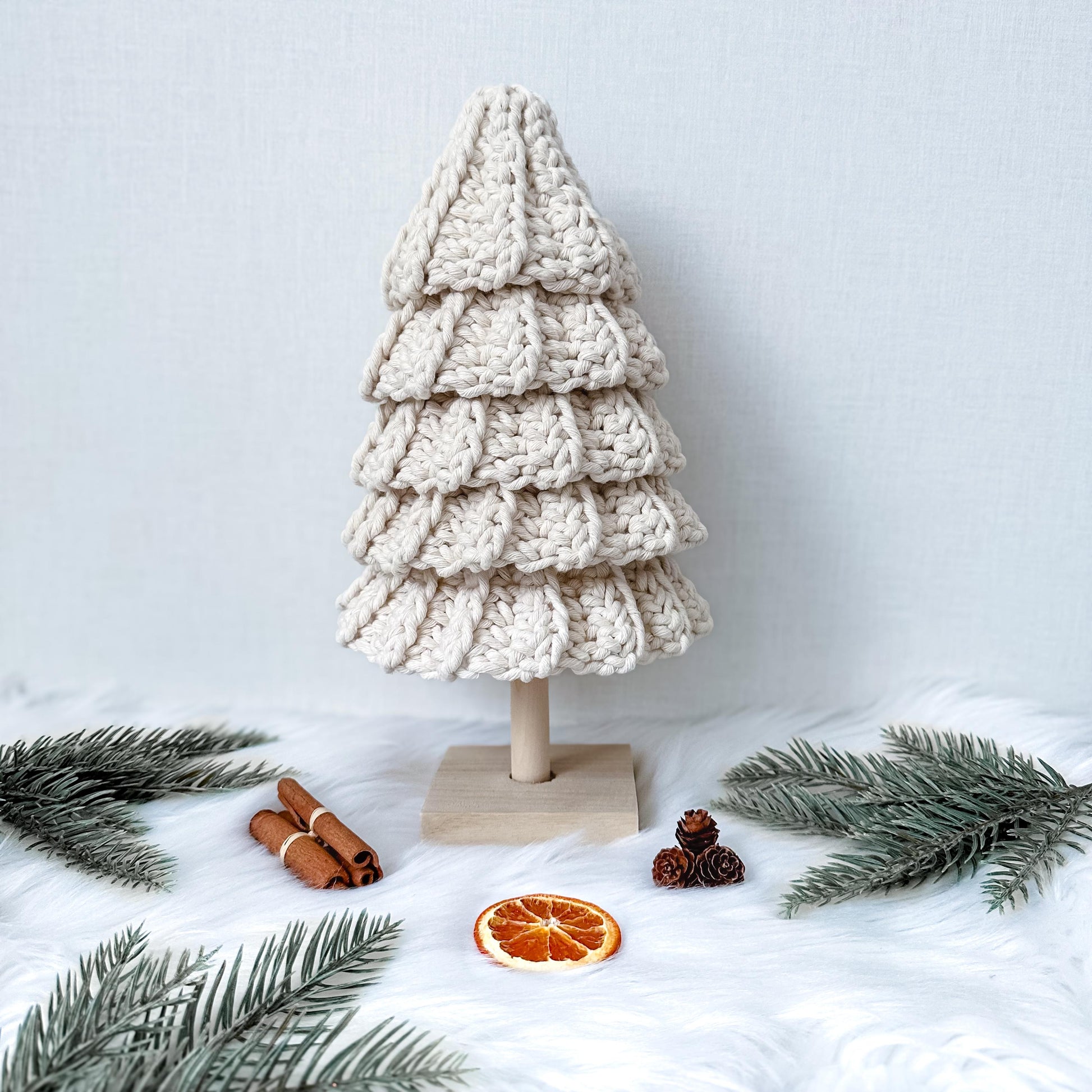 Handmade crochet Christmas tree decoration pattern with textured details and Scandinavian-inspired holiday aesthetic.