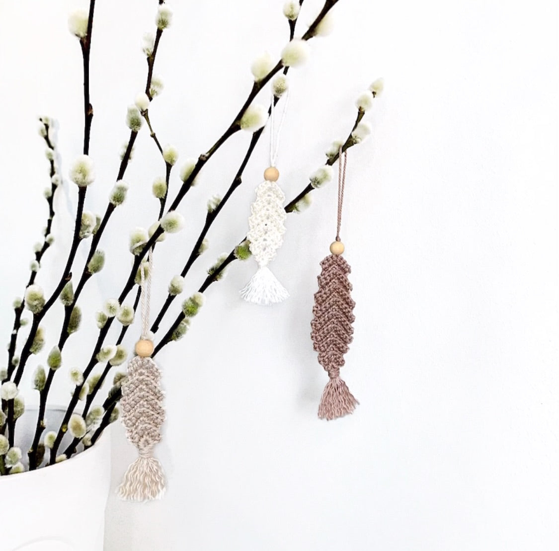 Handmade crochet Easter ornament pattern featuring a textured feather decoration for spring branches.