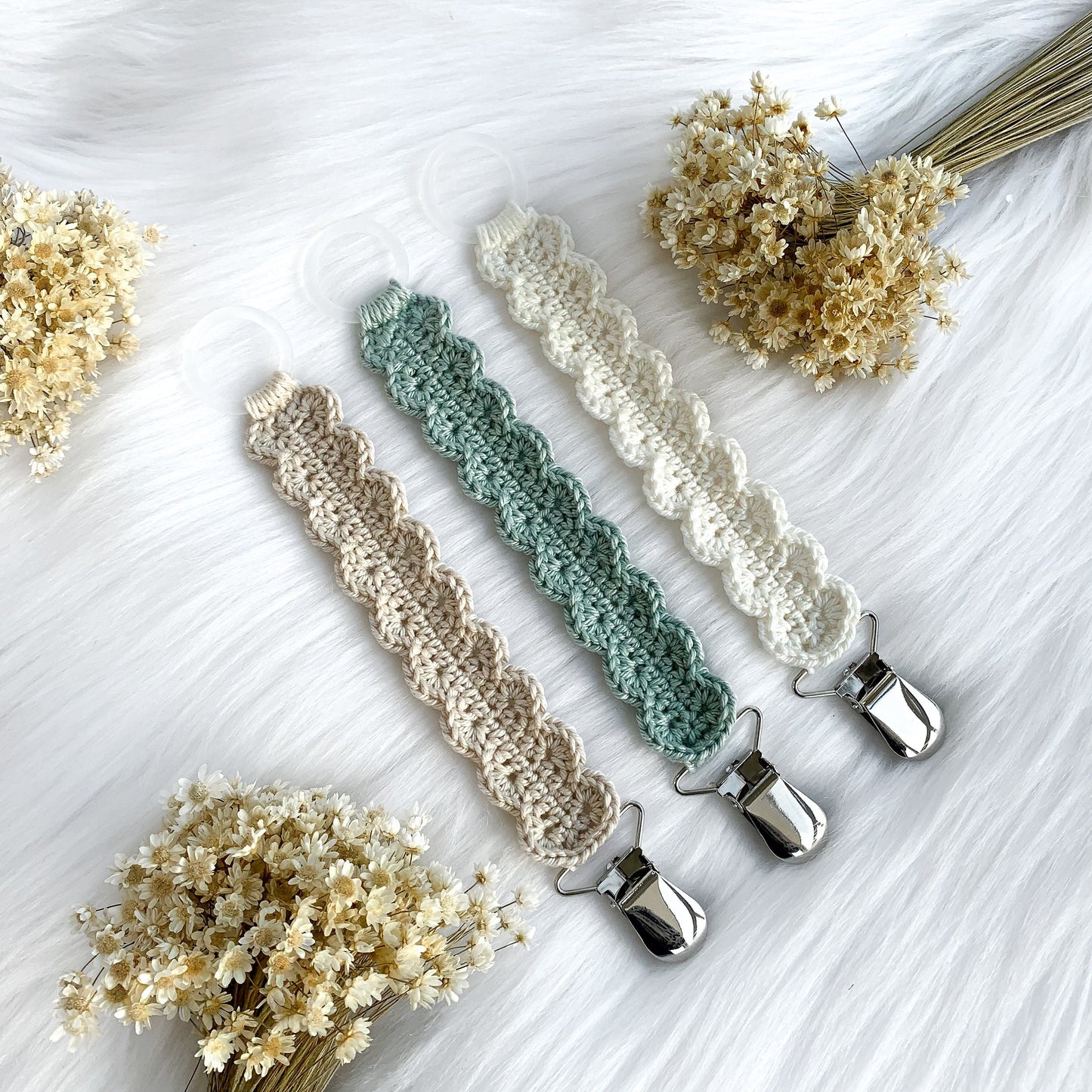 Modern crochet pacifier holder pattern with cozy textures and timeless neutral baby aesthetic.