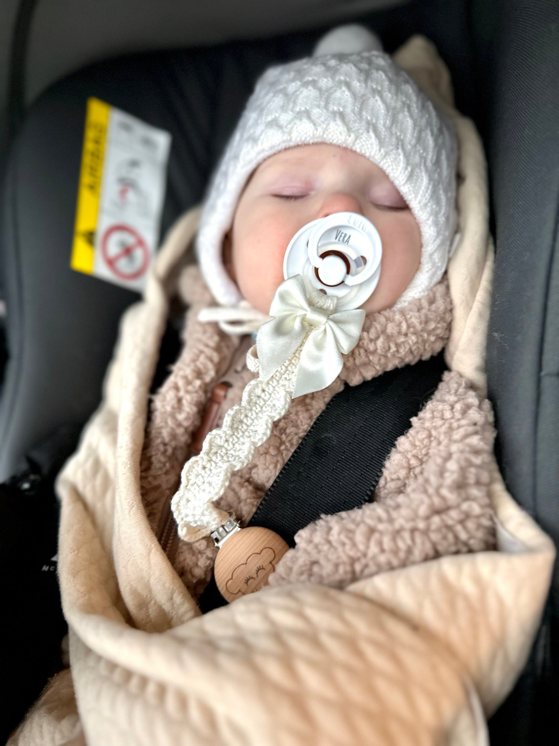 Scandinavian crochet baby accessory pattern featuring a soft handmade pacifier clip for babies.