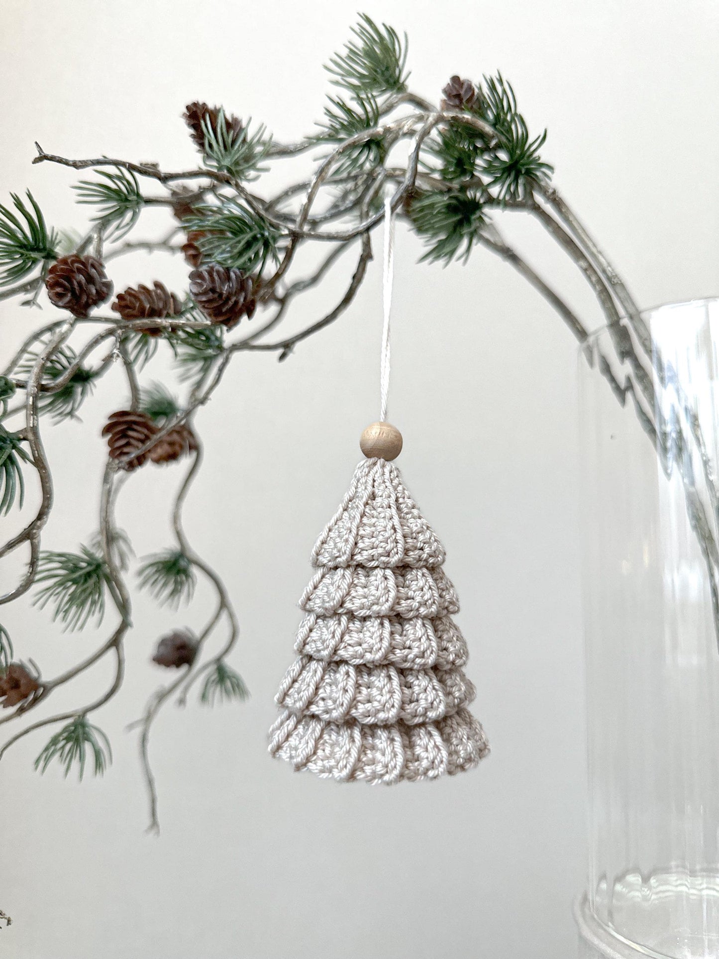 Scandinavian crochet Christmas tree ornament pattern featuring minimalist handmade holiday styling and festive decor.
