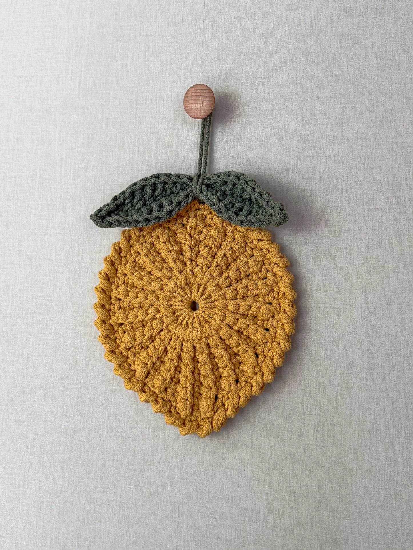 Textured crochet lemon pattern with decorative leaf details