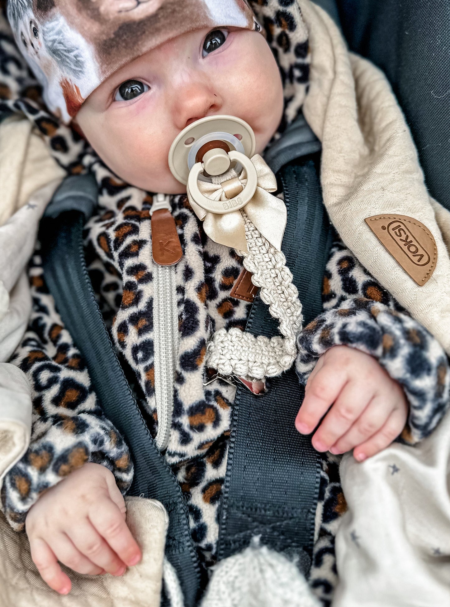 Scandinavian crochet pacifier clip pattern with minimalist handmade baby accessory design.